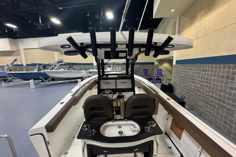 Slide: The Image of 2026 Sea Pro 292 DLX boat interior with fishing rod holders and seating. - 115