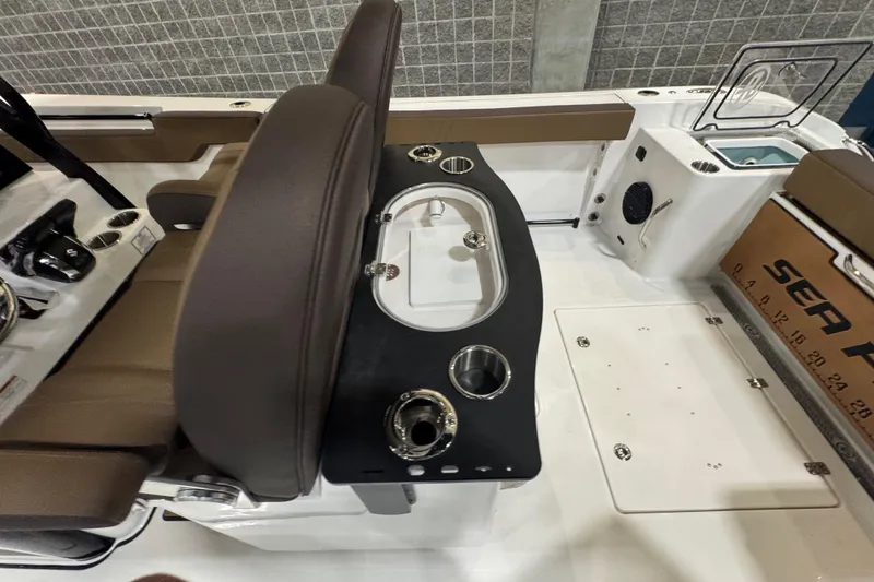 Slide: The Image of 2026 Sea Pro 292 DLX boat interior with seating and control panel. - 118