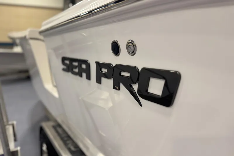 Slide: The Image of 2026 Sea Pro 292 DLX boat logo on sleek white hull. - 119