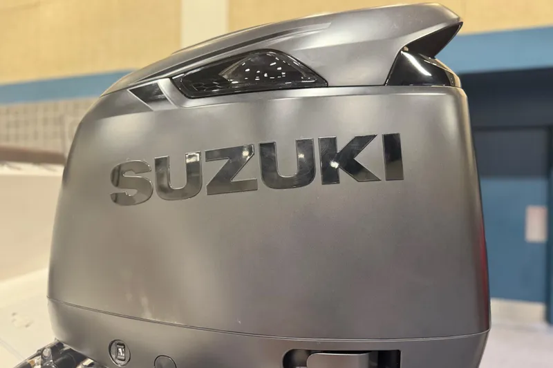 Slide: The Image of Suzuki outboard motor on 2026 Sea Pro 292 DLX boat, close-up view. - 121