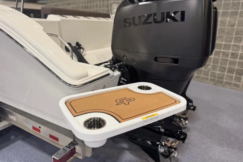 Slide: The Image of 2026 Sea Pro 292 DLX boat with Suzuki engine and integrated cup holder. - 123