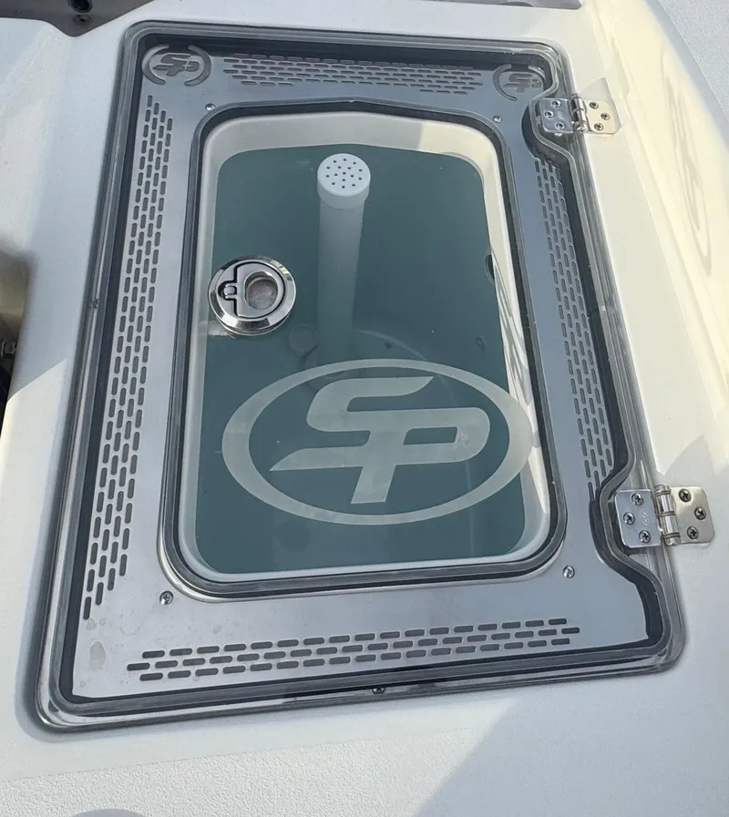 Slide: The Image of 2026 Sea Pro 292 DLX boat livewell with logo and secure latch. - 15