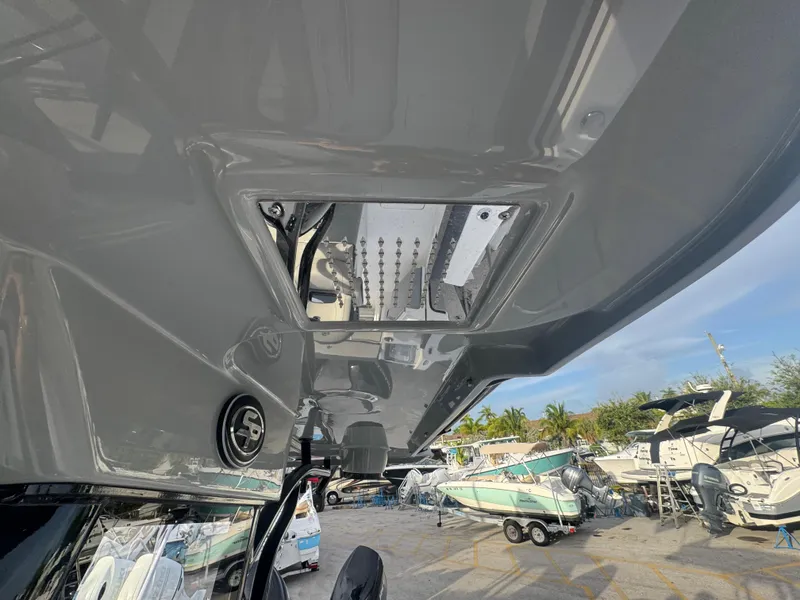 Slide: The Image of 2026 Sea Pro 292 DLX boat underside view at a marina with other boats. - 25