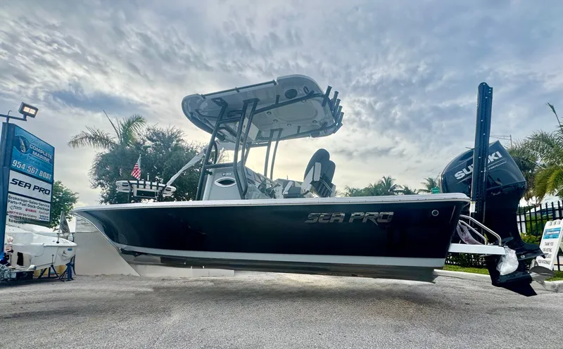 Slide: The Image of 2026 Sea Pro 292 DLX boat displayed outdoors with Suzuki engine. - 28