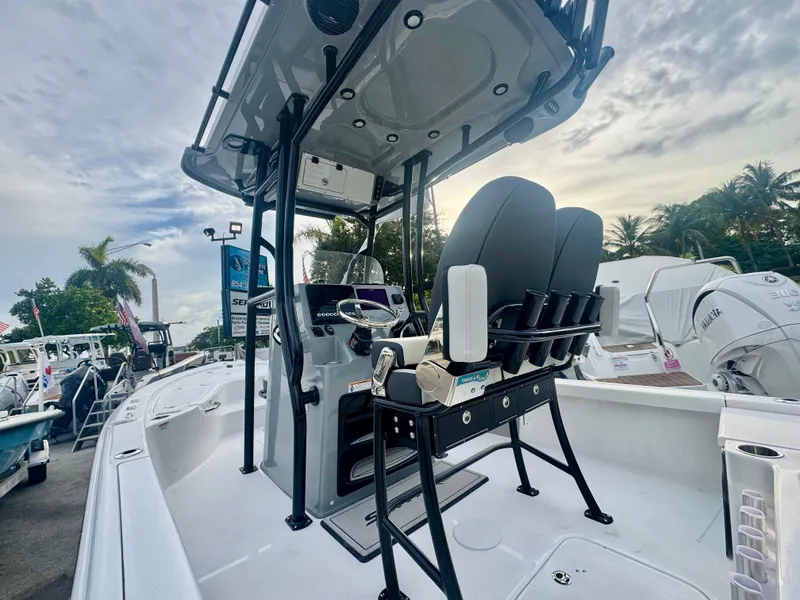 Slide: The Image of 2026 Sea Pro 292 DLX boat with sleek design and modern features, docked outdoors. - 29