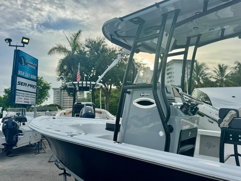 Slide: The Image of 2026 Sea Pro 292 DLX boat displayed at a dealership with palm trees in the background. - 30