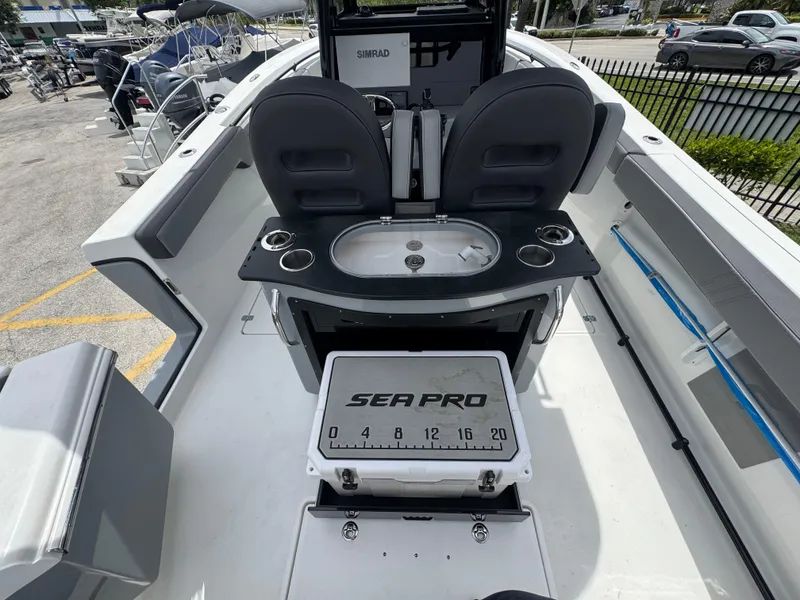 Slide: The Image of 2026 Sea Pro 292 DLX boat interior with seating, sink, and cooler. - 31