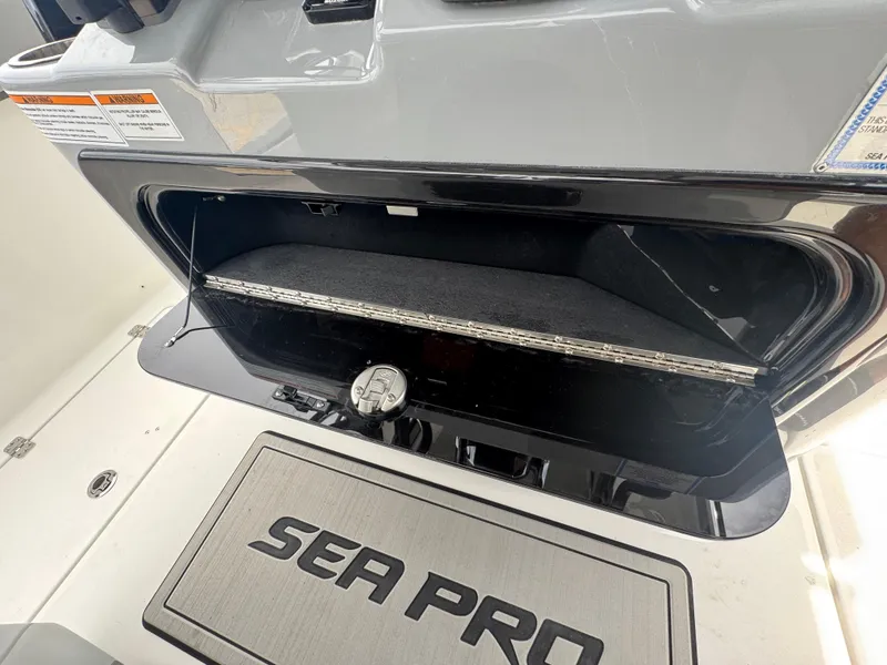 Slide: The Image of Open storage compartment on 2026 Sea Pro 292 DLX boat deck. - 35