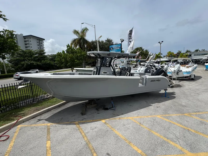 Slide: The Image of 2026 Sea Pro 292 DLX boat displayed outdoors in a marina setting. - 6