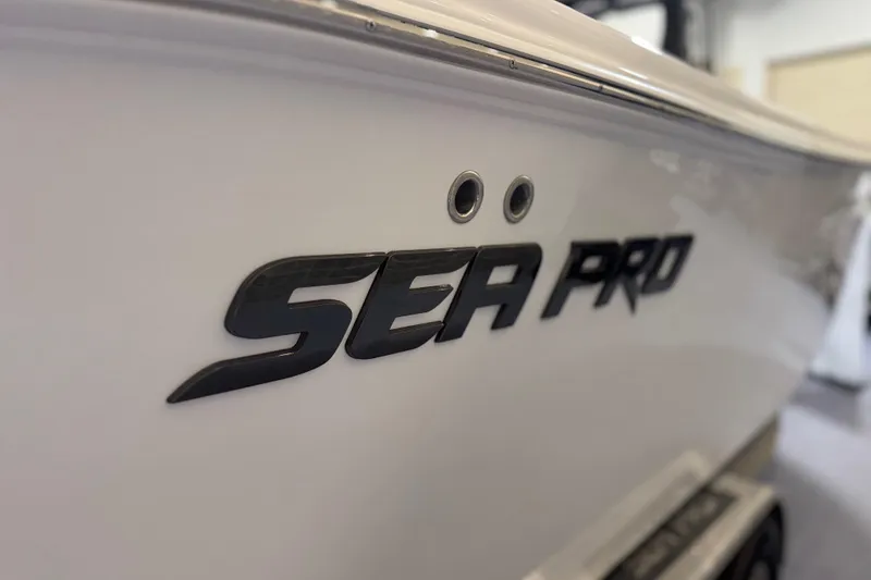 Slide: The Image of 2026 Sea Pro 292 DLX boat logo on sleek white hull. - 91