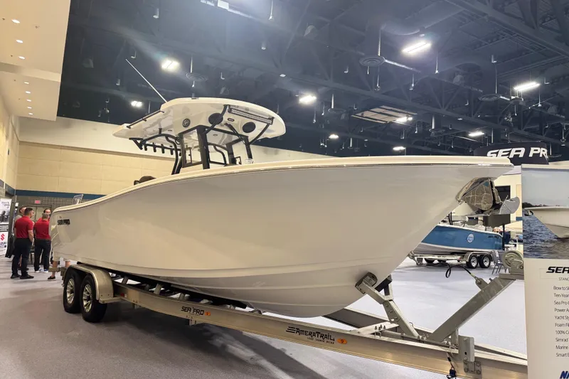 Slide: The Image of 2026 Sea Pro 292 DLX boat on display indoors, mounted on a trailer. - 92