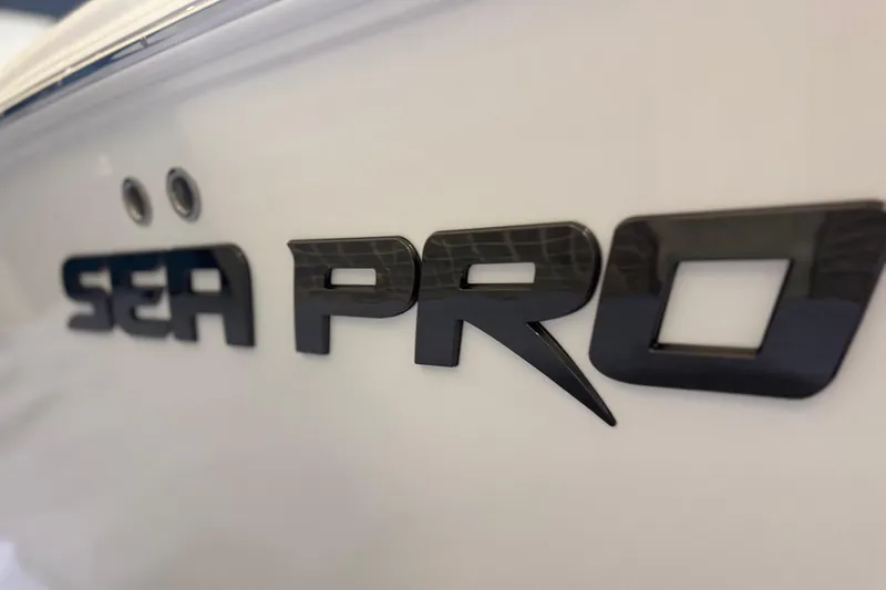 Slide: The Image of Close-up of 2026 Sea Pro 292 DLX boat logo on white surface. - 94