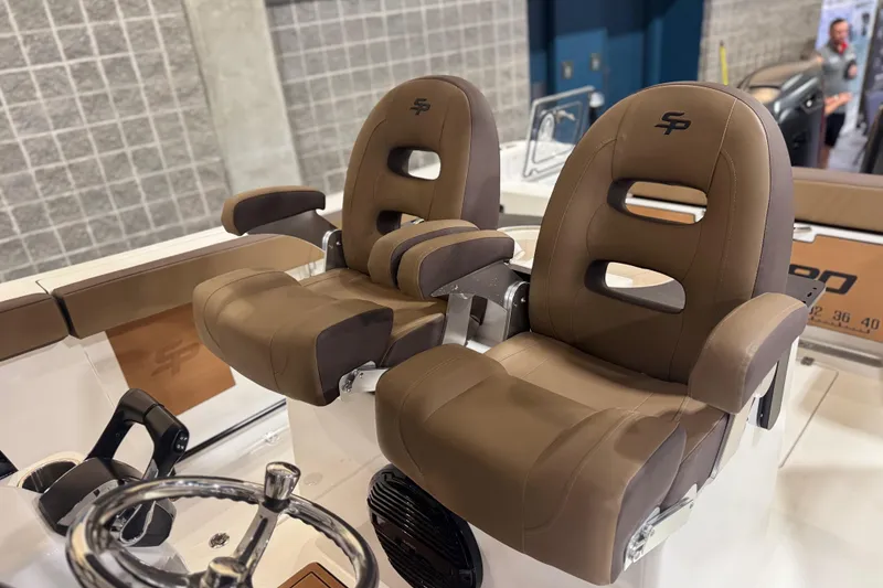 Slide: The Image of 2026 Sea Pro 292 DLX boat seats with brown upholstery and steering wheel. - 97