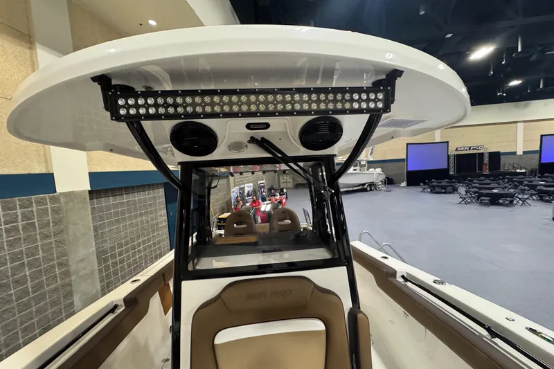 Slide: The Image of 2026 Sea Pro 292 DLX boat interior with advanced lighting and seating at an indoor exhibition. - 99