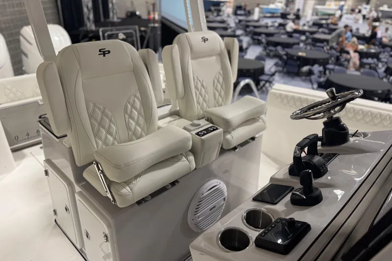 Slide: The Image of 2026 Sea Pro 332 DLX boat interior with luxury seating and modern helm controls. - 10