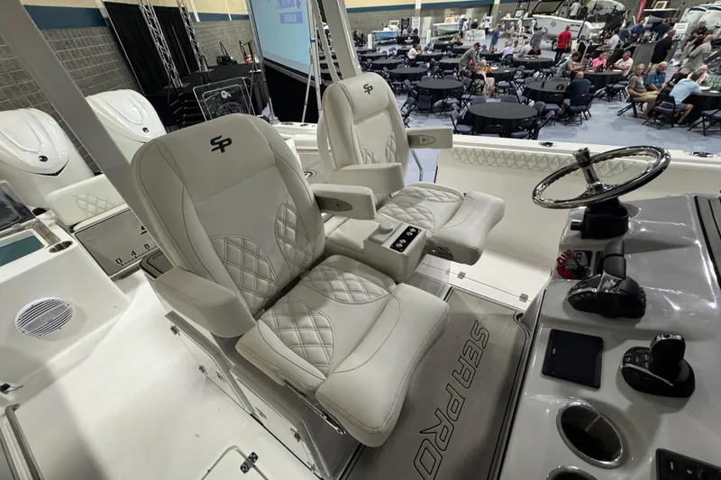 Slide: The Image of 2026 Sea Pro 332 DLX boat interior with luxury seating and modern helm controls. - 11