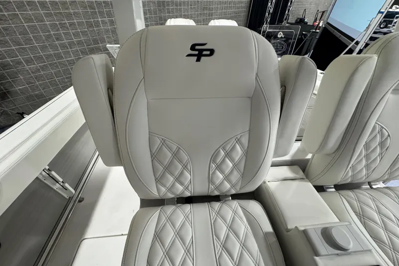 Slide: The Image of Luxurious seating on 2026 Sea Pro 332 DLX boat, featuring elegant quilted design and logo. - 13