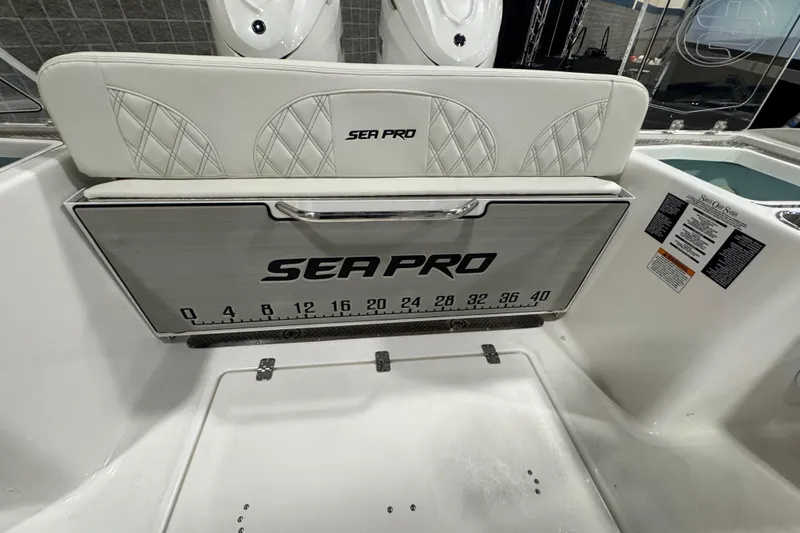 Slide: The Image of 2026 Sea Pro 332 DLX boat interior with branded seat and measuring board. - 18