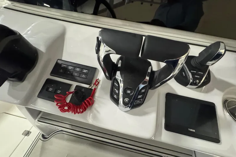Slide: The Image of Control panel of 2026 Sea Pro 332 DLX boat with steering and electronic controls. - 23