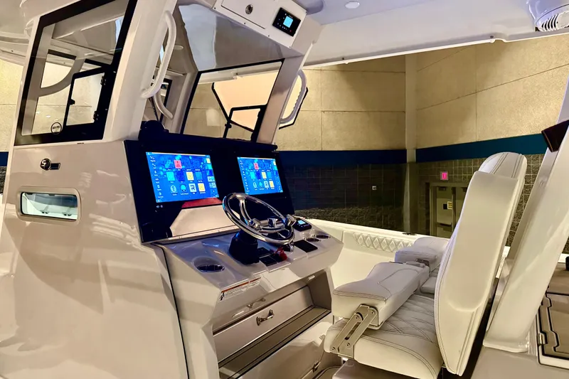 Slide: The Image of 2026 Sea Pro 332 DLX boat interior with modern dashboard and dual screens. - 25