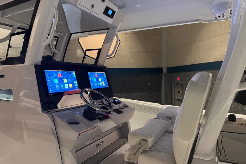 Slide: The Image of 2026 Sea Pro 332 DLX boat cockpit with dual screens and modern controls. - 26