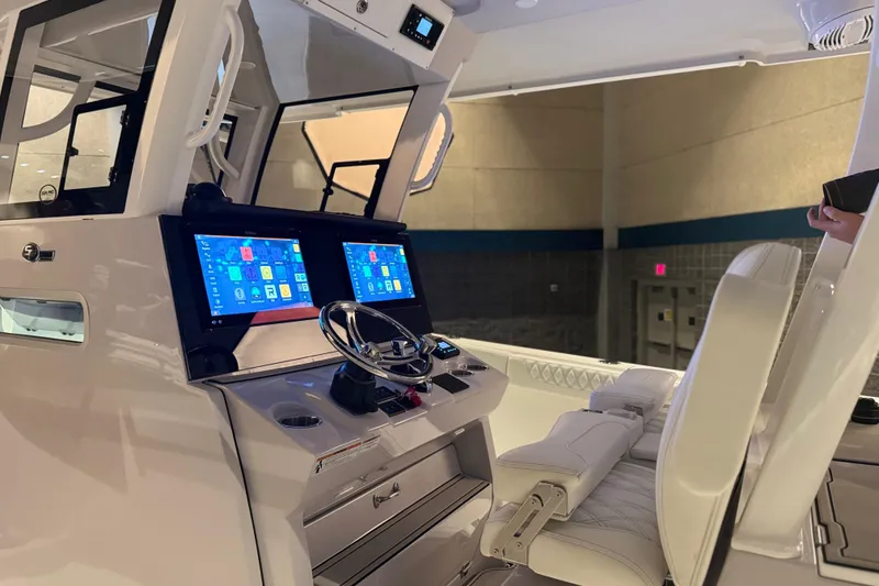 Slide: The Image of 2026 Sea Pro 332 DLX boat cockpit with dual screens and modern steering wheel. - 27