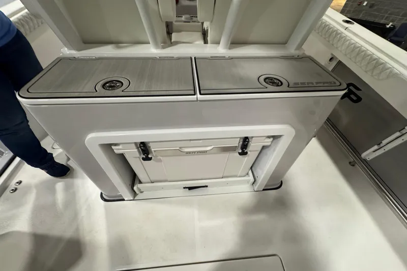 Slide: The Image of 2026 Sea Pro 332 DLX boat interior with storage compartments and cooler. - 29