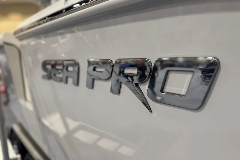 Slide: The Image of Close-up of 2026 Sea Pro 332 DLX boat logo in chrome finish. - 34