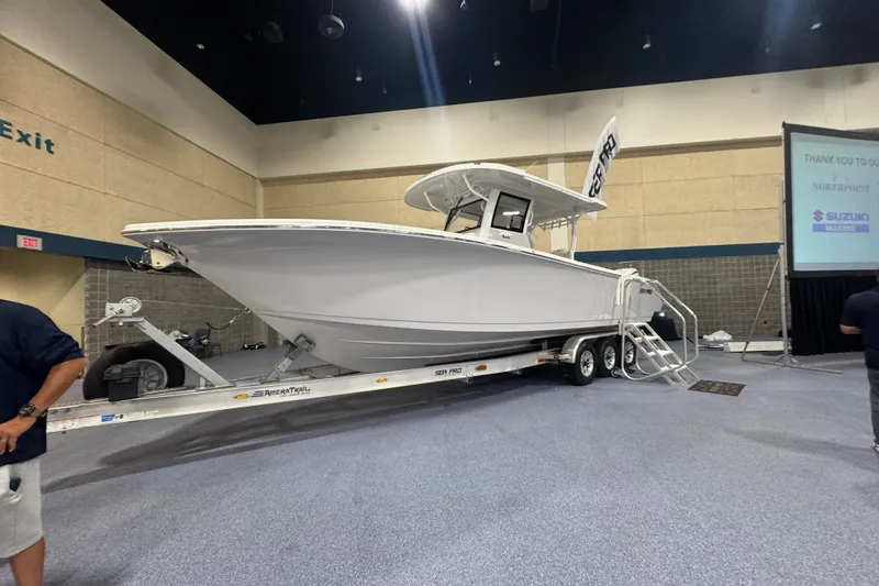 Slide: The Image of 2026 Sea Pro 332 DLX boat on trailer at indoor exhibition. - 35