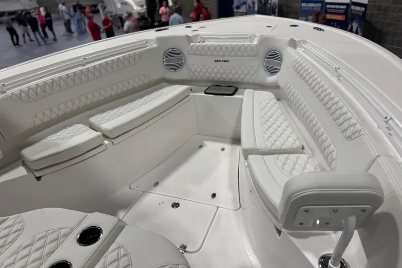 Slide: The Image of 2026 Sea Pro 332 DLX boat interior with white cushioned seating and modern design. - 4