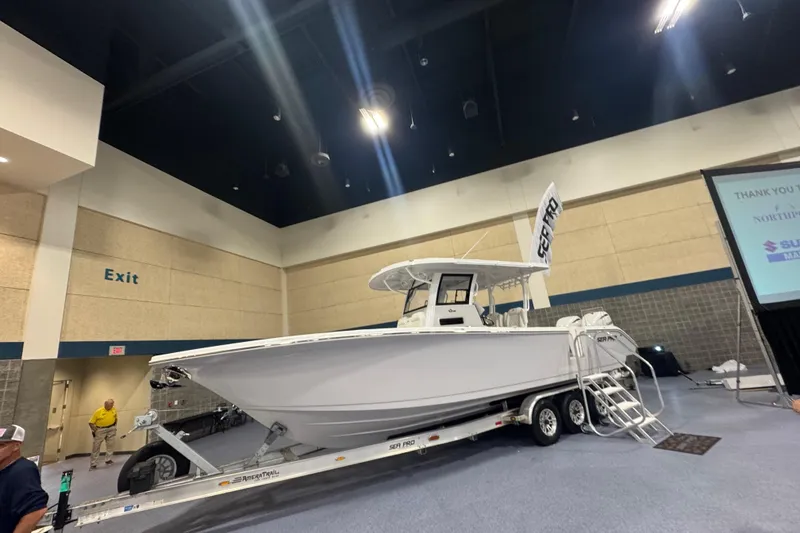 Slide: The Image of 2026 Sea Pro 332 DLX boat displayed indoors on a trailer. - 41