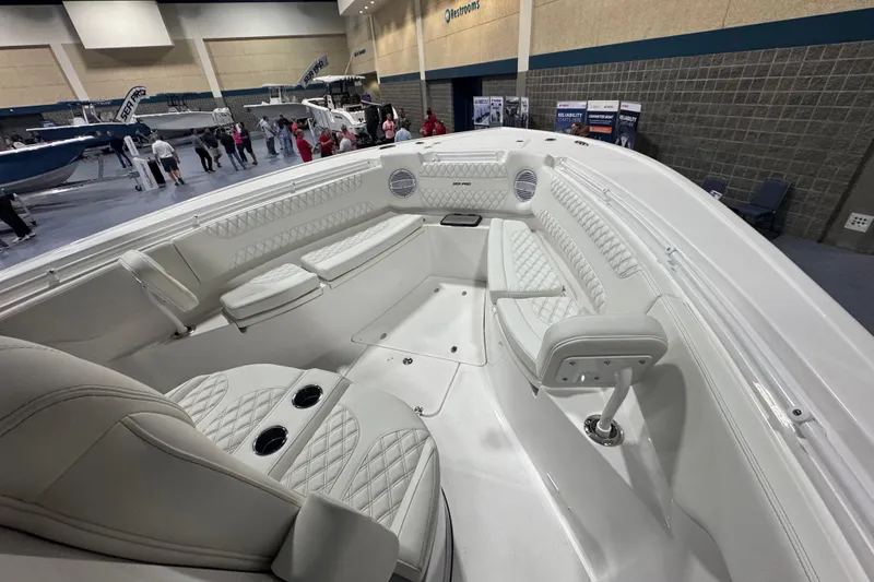 Slide: The Image of 2026 Sea Pro 332 DLX boat interior at a boat show, featuring luxurious seating and modern design. - 42