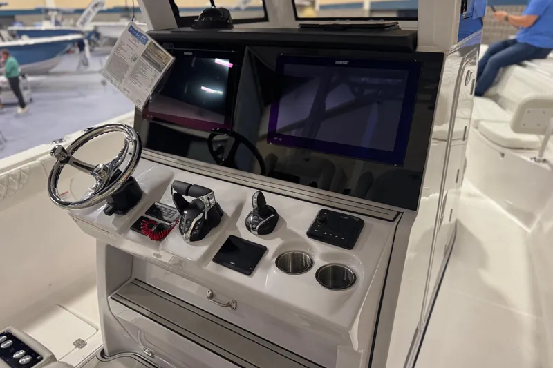 Slide: The Image of 2026 Sea Pro 332 DLX boat console with steering wheel, controls, and dual displays. - 45