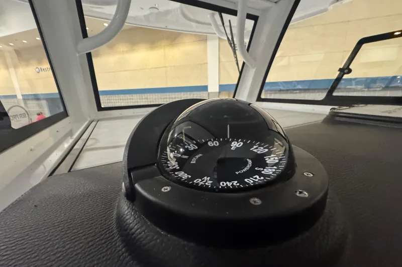 Slide: The Image of Compass on 2026 Sea Pro 332 DLX boat dashboard, indoor setting. - 49
