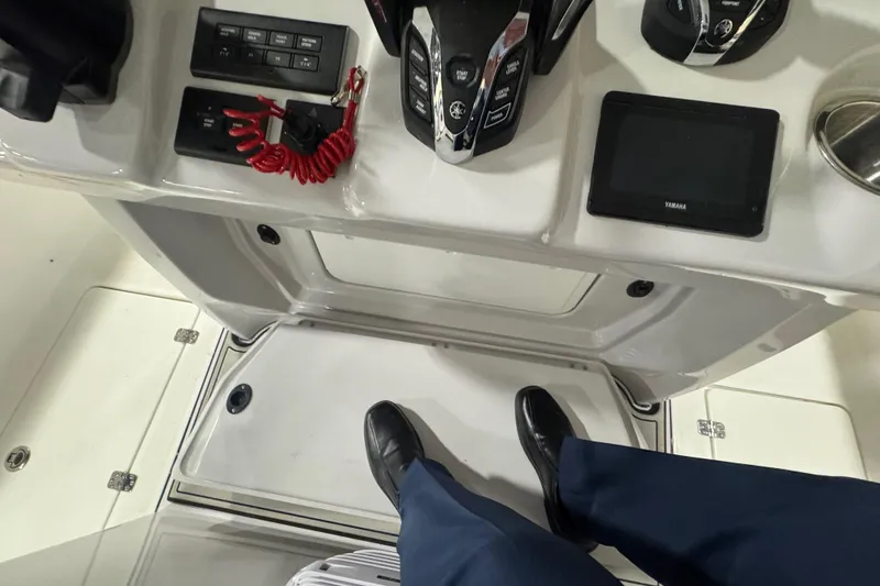 Slide: The Image of 2026 Sea Pro 332 DLX boat console with controls, display, and safety features. - 60