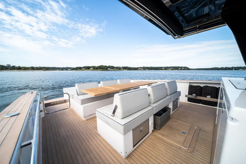 Slide: The Image of 2024 Pardo Yachts P43 deck with seating, table, and scenic water view. - 45