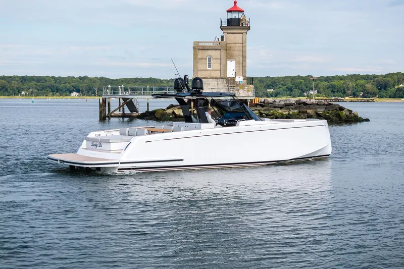Slide: The Image of 2024 Pardo Yachts P43 cruising near a lighthouse on a calm day. - 5