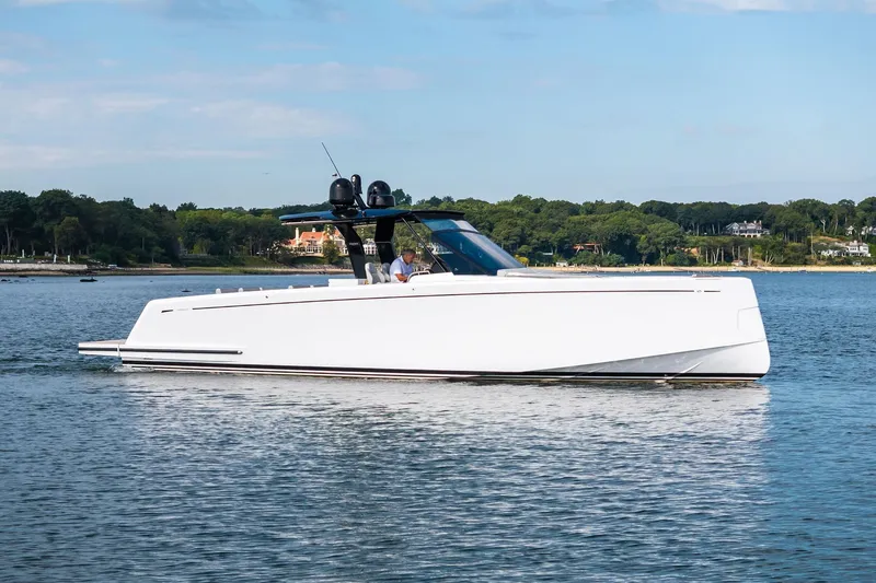 Slide: The Image of 2024 Pardo Yachts P43 cruising on calm waters near a lush, green shoreline. - 81
