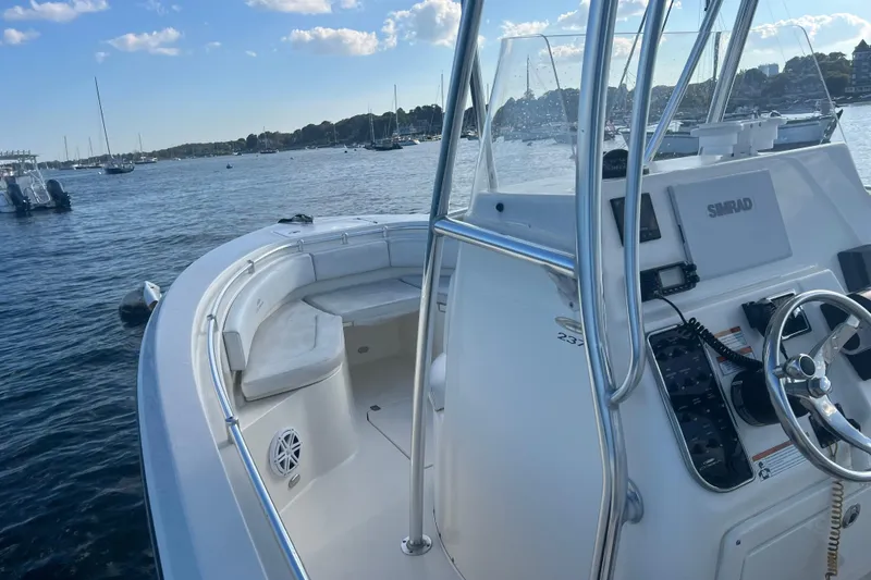 Slide: The Image of 2021 Cobia 237 Center Console boat on calm water, featuring a sleek design and modern controls. - 11