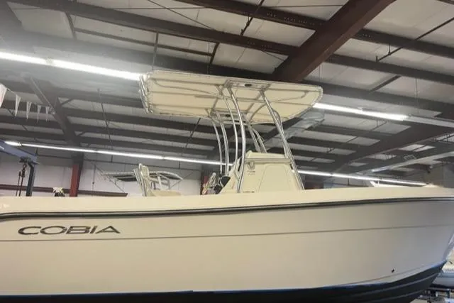 Slide: The Image of 2021 Cobia 237 Center Console boat in indoor storage facility. - 2