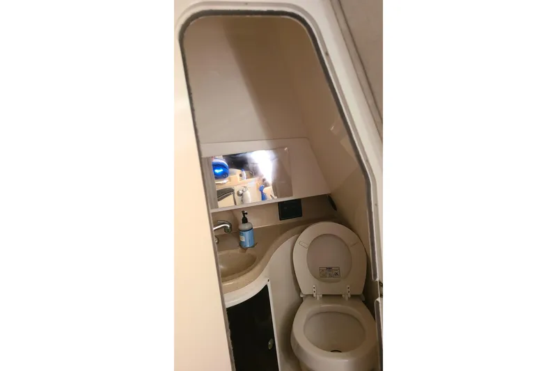 Slide: The Image of 2005 Aquasport 275 Explorer boat bathroom with toilet and sink. - 10