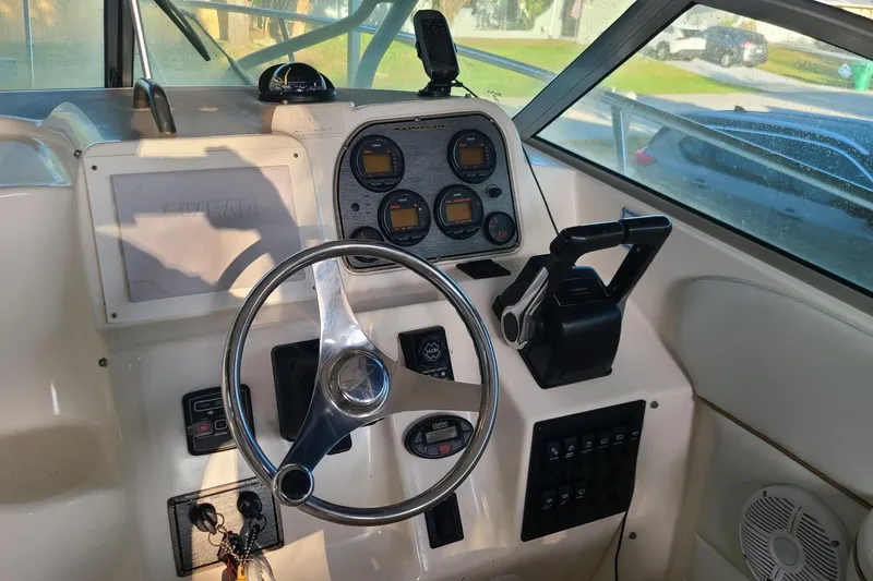 Slide: The Image of 2005 Aquasport 275 Explorer boat dashboard with steering wheel and control panel. - 5