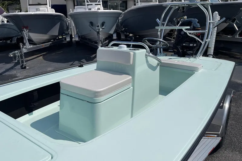 Slide: The Image of 2026 Chittum Skiffs Islamorada 18 boat logo on light blue hull. - 11
