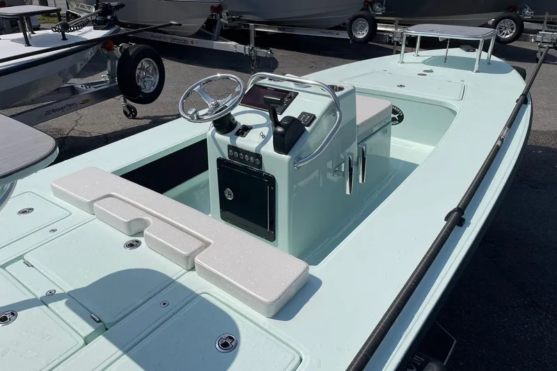 Slide: The Image of 2026 Chittum Skiffs Islamorada 18 boat, light blue, parked on trailer, side view. - 12