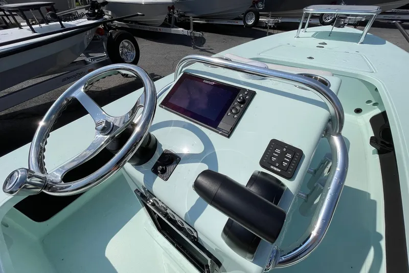 Slide: The Image of 2026 Chittum Skiffs Islamorada 18 boat console with steering wheel and controls. - 14