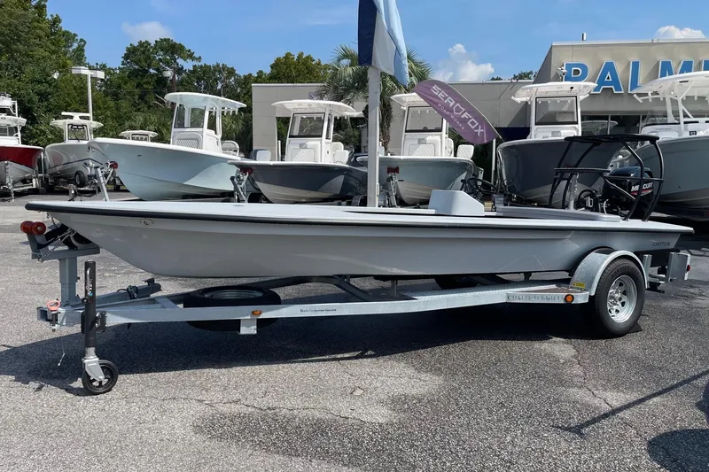 Slide: The Image of 2026 Chittum Skiffs Islamorada 18 on trailer, displayed outdoors under a cloudy sky. - 2