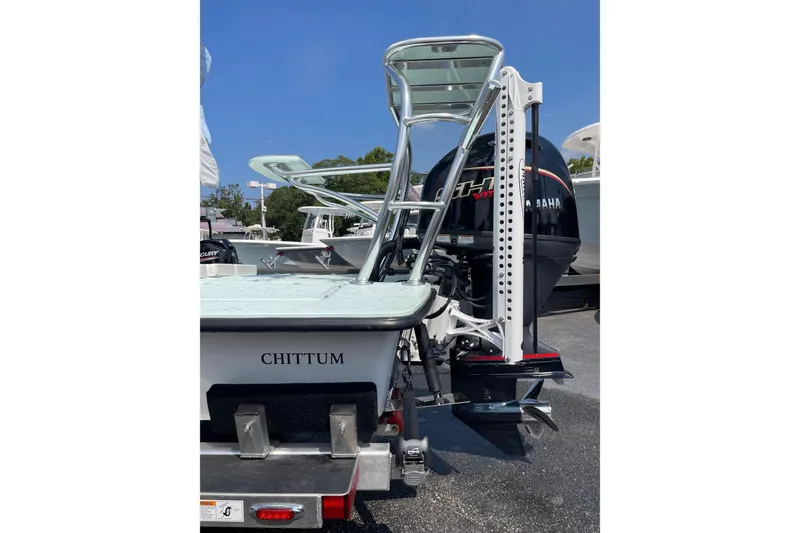 Slide: The Image of 2026 Chittum Skiffs Islamorada 18 with Yamaha outboard motor, parked outdoors. - 9