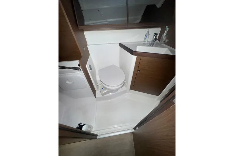 Slide: The Image of Bathroom interior of 2023 Beneteau Oceanis 40.1 yacht, featuring modern fixtures and wood accents. - 15