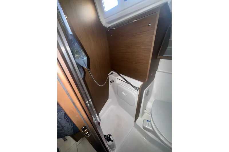 Slide: The Image of 2023 Beneteau Oceanis 40.1 yacht bathroom with wooden cabinetry and modern fixtures. - 16