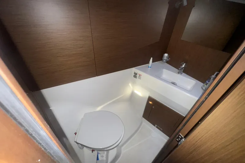 Slide: The Image of 2023 Beneteau Oceanis 40.1 yacht bathroom with modern fixtures and wooden accents. - 18